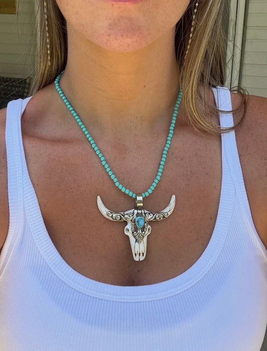 Bone longhorn charm on turquoise beads